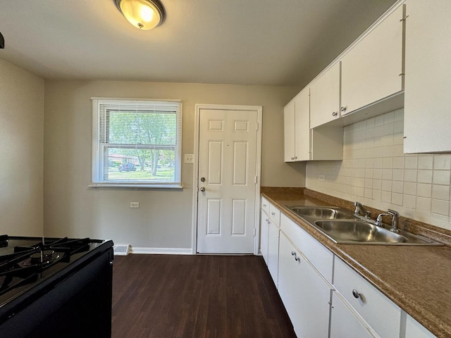 14401 Kolin Ave, Midlothian, IL 60445 - kitchen featuring a sink, white cabinets, dark wood-style floors, decorative backsplash, and baseboards