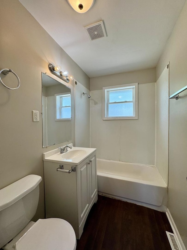 14401 Kolin Ave, Midlothian, IL 60445 - bathroom with toilet, vanity, wood finished floors, and plenty of natural light