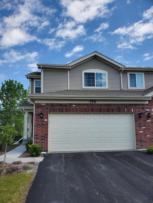 754 Westbury Dr, Cary, IL 60013 - view of front of home featuring driveway, an attached garage, and brick siding