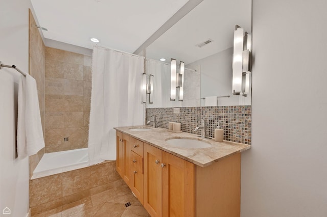 4606 S Lake Park Ave Unit 201N, Chicago, IL 60653 - bathroom with tiled shower / bath combo, decorative backsplash, double vanity, recessed lighting, and tile patterned floors