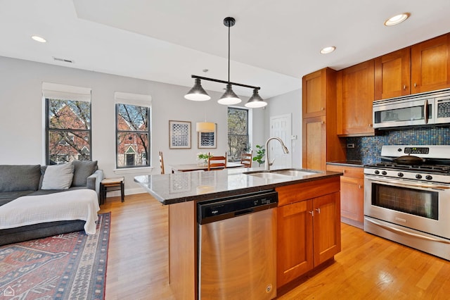 4606 S Lake Park Ave Unit 201N, Chicago, IL 60653 - kitchen featuring stainless steel appliances, a sink, light wood finished floors, decorative backsplash, and recessed lighting
