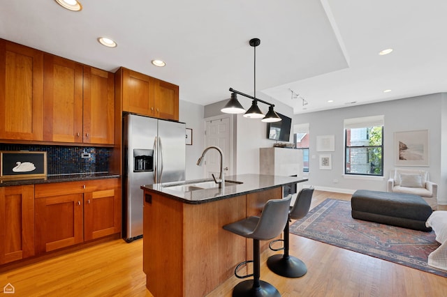 4606 S Lake Park Ave Unit 201N, Chicago, IL 60653 - kitchen with stainless steel fridge, a sink, light wood-style floors, brown cabinetry, and recessed lighting