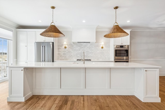 6202 Flagg Creek Ln, Western Springs, IL 60558 - kitchen featuring appliances with stainless steel finishes, light countertops, decorative backsplash, light wood finished floors, and white cabinetry