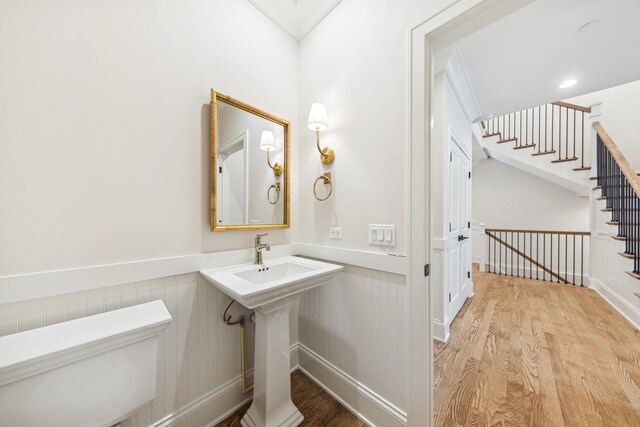 6202 Flagg Creek Ln, Western Springs, IL 60558 - bathroom with wood finished floors, toilet, a wainscoted wall, and crown molding