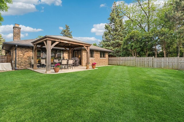 512 N Rose Ave, Park Ridge, IL 60068 - rear view of property featuring a chimney, brick siding, a patio area, and a gazebo
