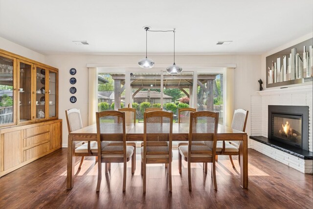 512 N Rose Ave, Park Ridge, IL 60068 - dining area with plenty of natural light, dark wood-style flooring, and a brick fireplace