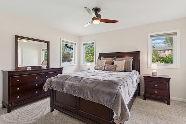 512 N Rose Ave, Park Ridge, IL 60068 - bedroom with light colored carpet, multiple windows, baseboards, and ceiling fan