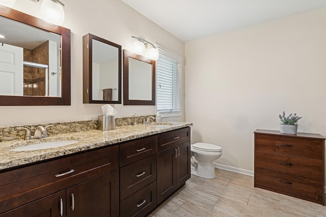 512 N Rose Ave, Park Ridge, IL 60068 - bathroom featuring double vanity, toilet, baseboards, and a shower with door