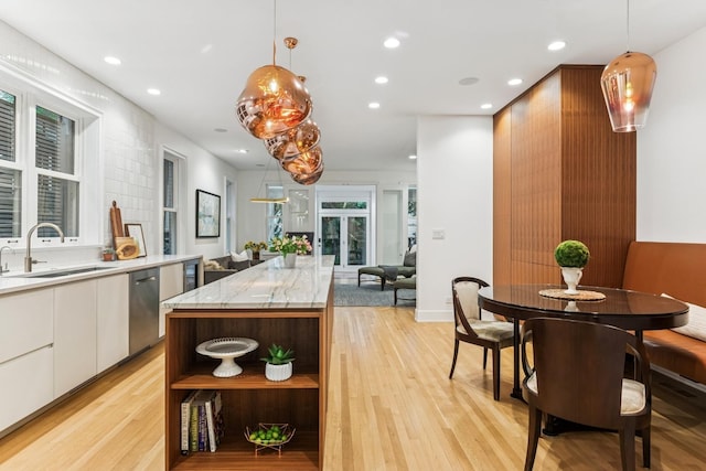 kitchen featuring stainless steel dishwasher, open shelves, white cabinetry, light wood-type flooring, and recessed lighting