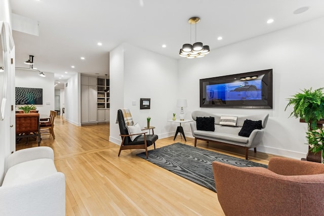 living area with light wood-type flooring and recessed lighting