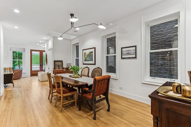 dining space featuring light wood-style flooring and recessed lighting