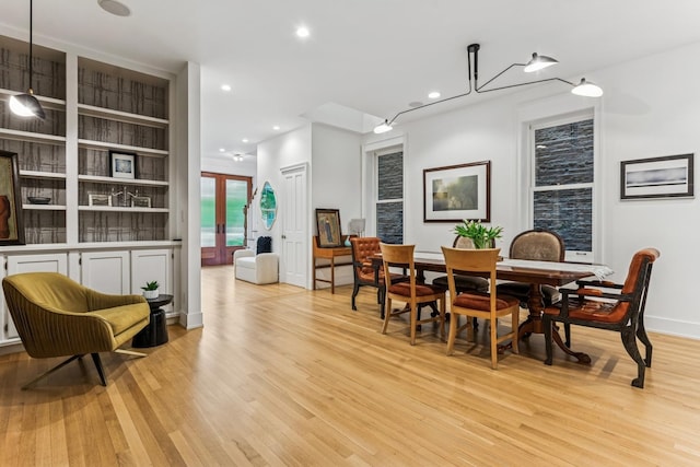 dining space with light wood-type flooring and recessed lighting