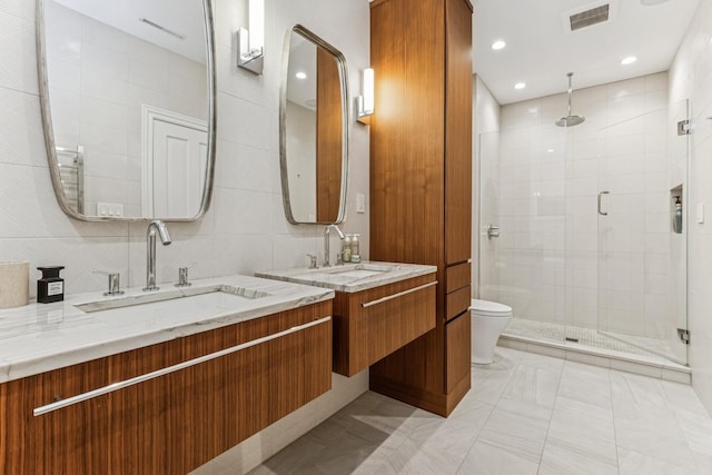 bathroom with a stall shower and vanity