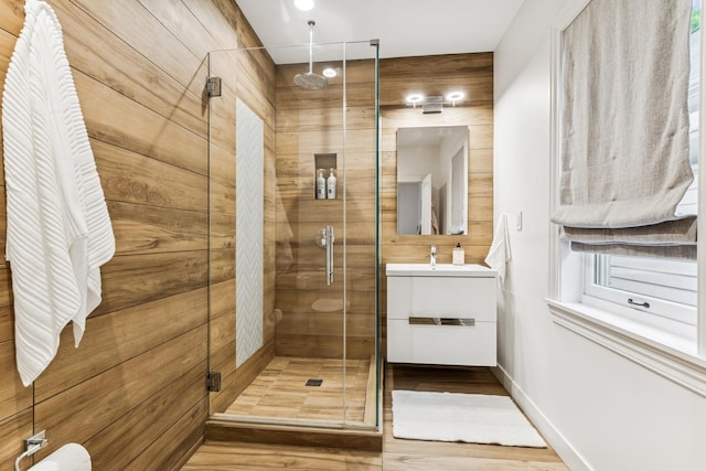 full bath with a shower stall, vanity, and wood finished floors