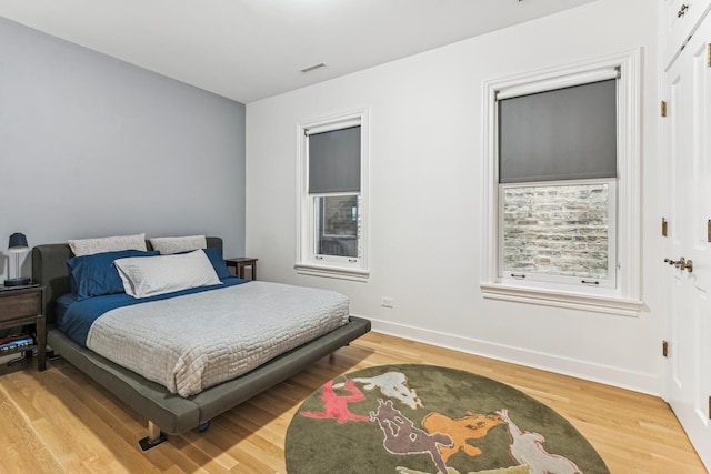 bedroom featuring light wood-style flooring and baseboards