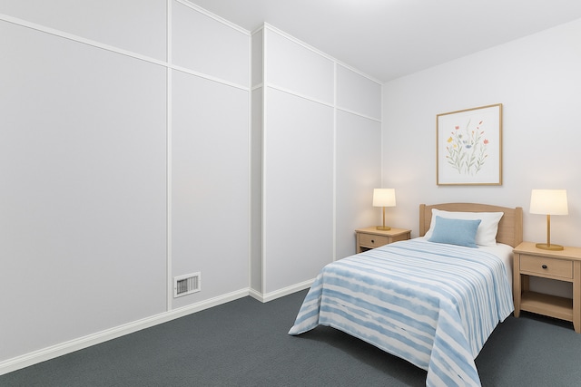 bedroom with carpet floors and baseboards