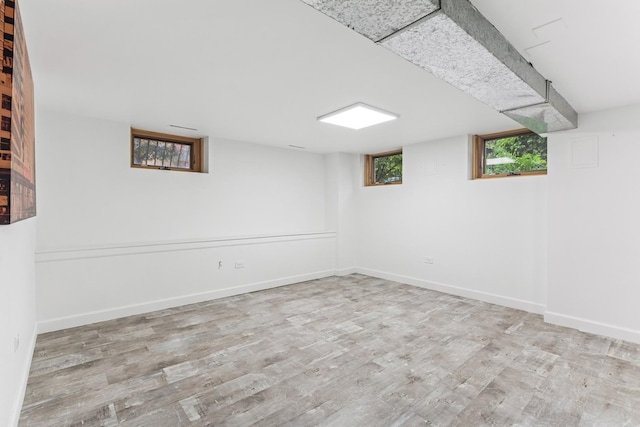 below grade area with wood finished floors and baseboards