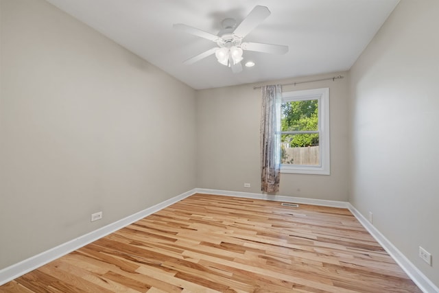 400 Bayview Ave, Naperville, IL 60565 - spare room with light wood finished floors, ceiling fan, and baseboards