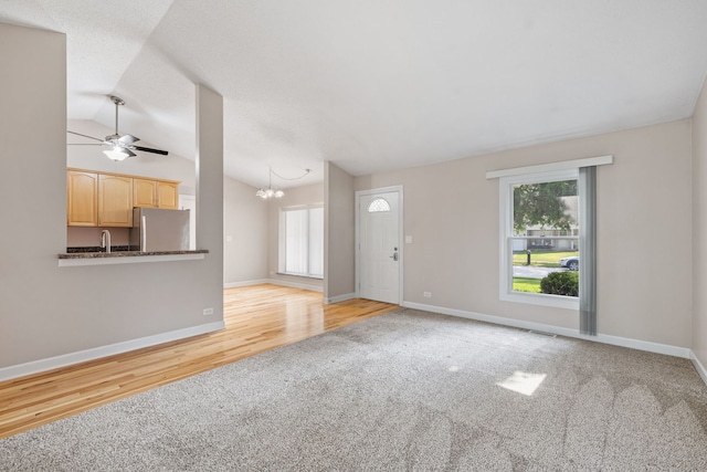 400 Bayview Ave, Naperville, IL 60565 - unfurnished living room featuring carpet flooring, lofted ceiling, ceiling fan, a chandelier, and baseboards