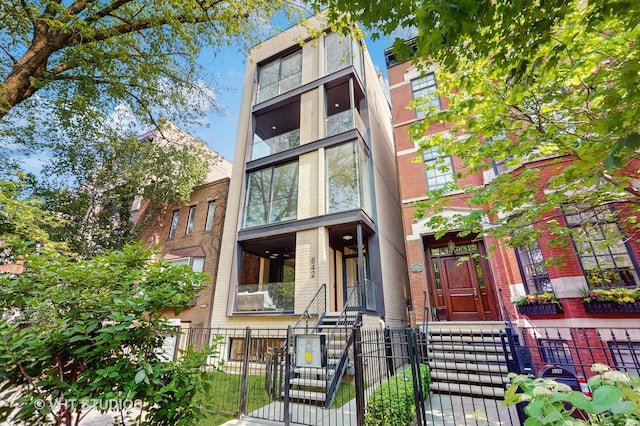 642 W Webster Ave Unit 1, Chicago, IL 60614 - view of front of home with a fenced front yard, brick siding, and a gate