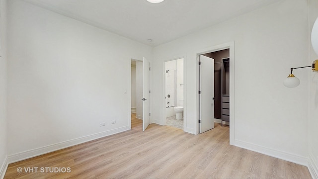 642 W Webster Ave Unit 1, Chicago, IL 60614 - unfurnished bedroom featuring light wood finished floors, a spacious closet, and ensuite bath