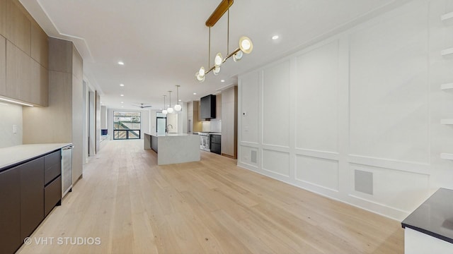 642 W Webster Ave Unit 1, Chicago, IL 60614 - kitchen with a decorative wall, modern cabinets, light wood-style flooring, open floor plan, and an island with sink