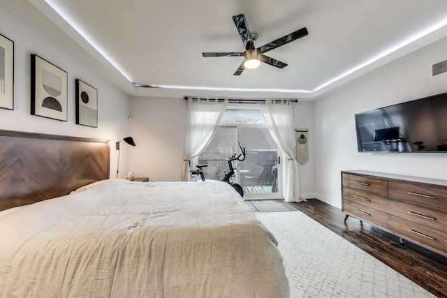 2312 W Belmont Ave Unit 1W, Chicago, IL 60618 - bedroom featuring dark wood-type flooring, access to outside, a ceiling fan, baseboards, and a tray ceiling