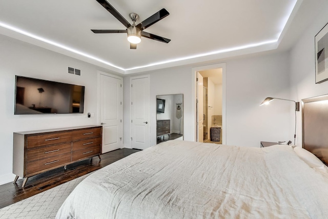 2312 W Belmont Ave Unit 1W, Chicago, IL 60618 - bedroom with dark wood-style flooring, ensuite bathroom, a raised ceiling, and ceiling fan