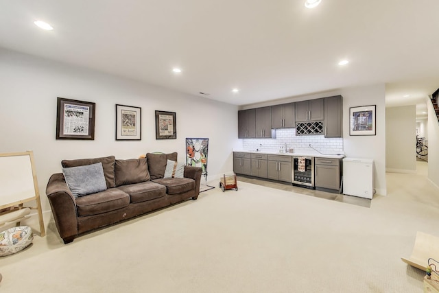 2312 W Belmont Ave Unit 1W, Chicago, IL 60618 - living room featuring beverage cooler, bar with sink, light carpet, recessed lighting, and baseboards
