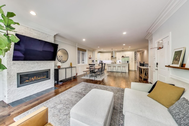 2312 W Belmont Ave Unit 1W, Chicago, IL 60618 - living room featuring a fireplace, ornamental molding, dark wood-type flooring, and recessed lighting