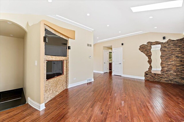 703 Berkshire Ln, Schaumburg, IL 60193 - unfurnished living room with a glass covered fireplace, hardwood / wood-style flooring, arched walkways, a skylight, and recessed lighting