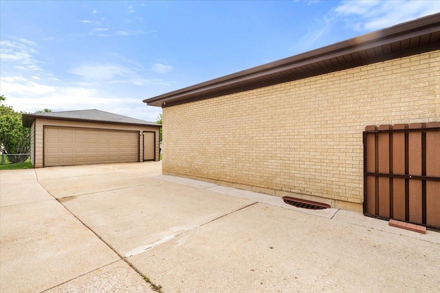 703 Berkshire Ln, Schaumburg, IL 60193 - view of home's exterior with brick siding, an outbuilding, and a detached garage