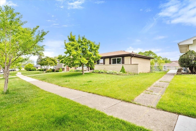 703 Berkshire Ln, Schaumburg, IL 60193 - view of front of house featuring a front yard and brick siding
