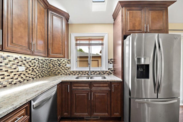 703 Berkshire Ln, Schaumburg, IL 60193 - kitchen with stainless steel appliances, backsplash, a sink, and light stone countertops