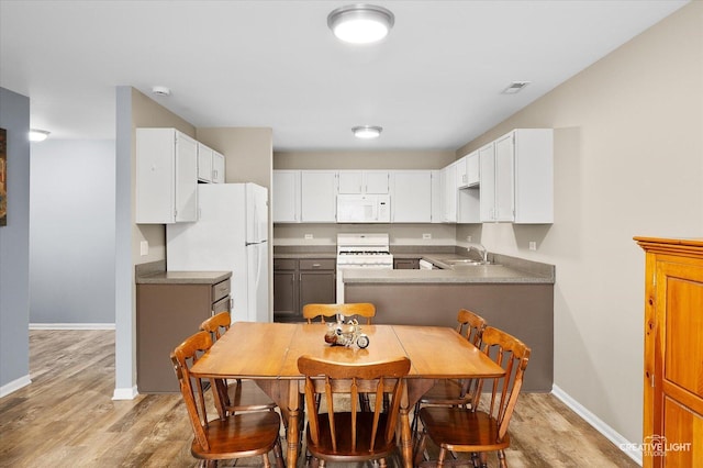 1840 Venson Ln Unit 1840, Joliet, IL 60435 - kitchen featuring white appliances, a sink, light wood-style floors, and baseboards
