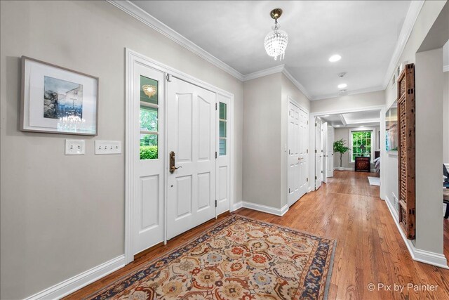 3 Woodley Mnr, Winnetka, IL 60093 - foyer entrance featuring light wood finished floors, baseboards, crown molding, recessed lighting, and a chandelier