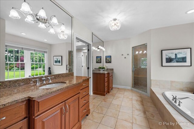3 Woodley Mnr, Winnetka, IL 60093 - full bath with two vanities, a chandelier, a stall shower, a garden tub, and tile patterned flooring