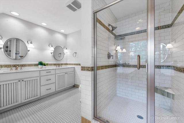 3 Woodley Mnr, Winnetka, IL 60093 - bathroom with a shower stall, double vanity, recessed lighting, tile walls, and wainscoting