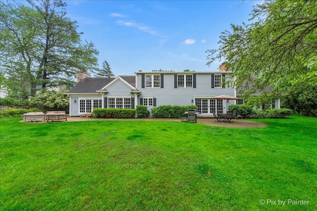 3 Woodley Mnr, Winnetka, IL 60093 - back of house featuring a patio, a yard, a chimney, and french doors