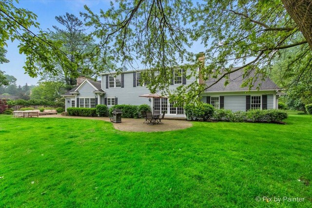 3 Woodley Mnr, Winnetka, IL 60093 - rear view of property featuring a patio, a yard, and a chimney