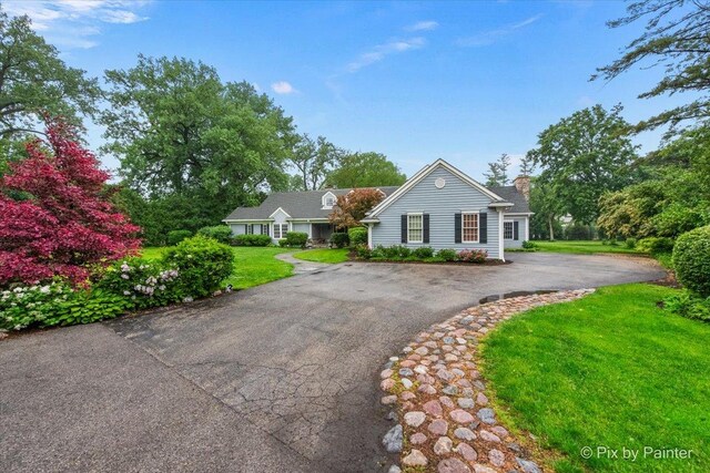 3 Woodley Mnr, Winnetka, IL 60093 - view of front of home with driveway, a front yard, and a chimney