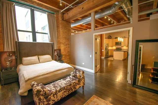 1727 S Indiana Ave Unit 214, Chicago, IL 60616 - bedroom featuring stainless steel fridge, rail lighting, brick wall, dark wood-type flooring, and beamed ceiling