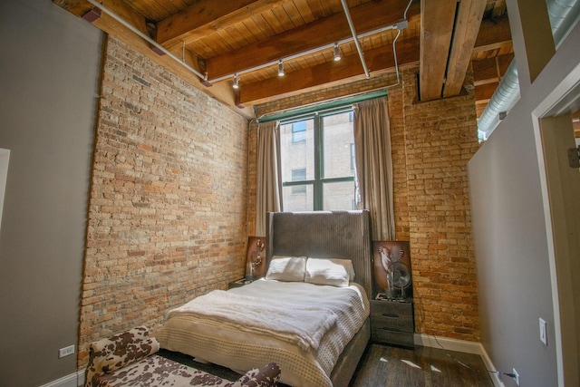 1727 S Indiana Ave Unit 214, Chicago, IL 60616 - bedroom with wooden ceiling with exposed beams, brick wall, baseboards, and track lighting