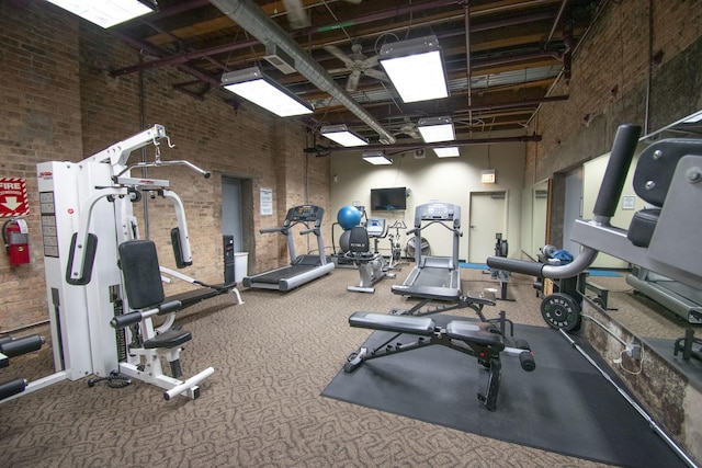1727 S Indiana Ave Unit 214, Chicago, IL 60616 - workout area featuring a high ceiling, brick wall, and carpet floors