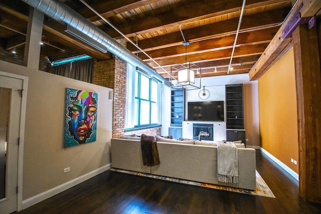 1727 S Indiana Ave Unit 214, Chicago, IL 60616 - living area with dark wood-style flooring, a glass covered fireplace, and a wooden ceiling with exposed beams