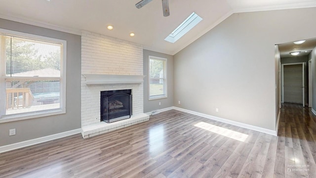 120 Harvest Glenn Dr, Davis Junction, IL 61020 - unfurnished living room featuring ornamental molding, a skylight, a ceiling fan, lofted ceiling, and wood finished floors