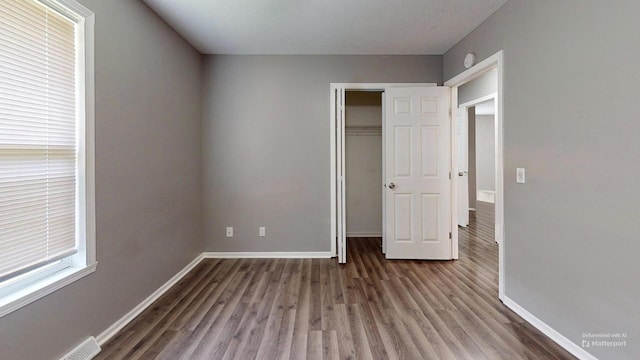 120 Harvest Glenn Dr, Davis Junction, IL 61020 - unfurnished bedroom with wood finished floors and a closet