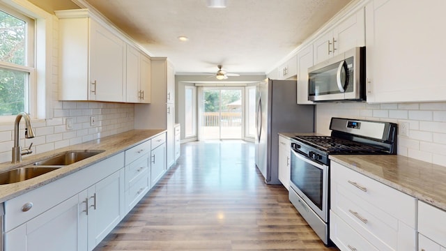 120 Harvest Glenn Dr, Davis Junction, IL 61020 - kitchen with appliances with stainless steel finishes, white cabinetry, light wood finished floors, decorative backsplash, and recessed lighting
