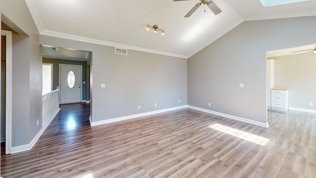 120 Harvest Glenn Dr, Davis Junction, IL 61020 - unfurnished living room featuring ceiling fan, light wood-style floors, ornamental molding, a skylight, and vaulted ceiling