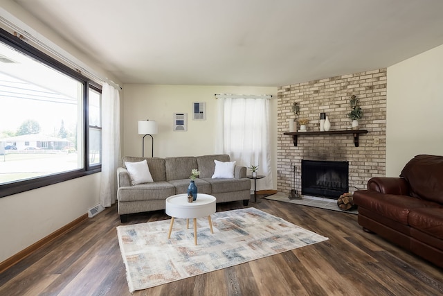 1410 Barnhart Ct, Zion, IL 60099 - living room featuring wood finished floors, a brick fireplace, and baseboards